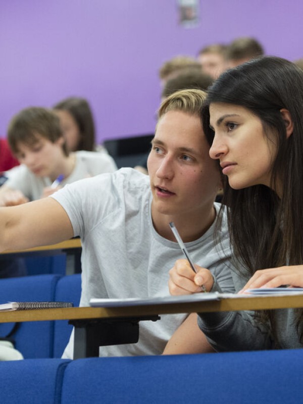 Male and female students in a lecture theatre