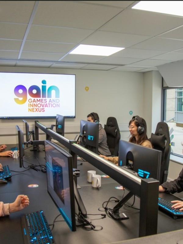 People on computers with headsets