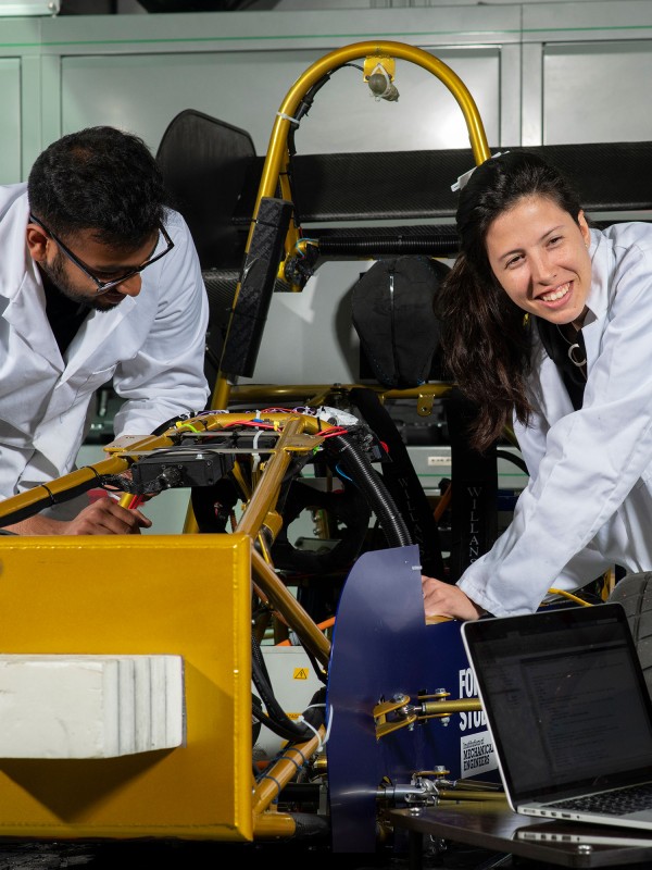 Mechanical engineering students with race car
