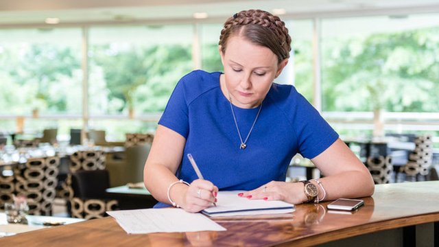 Woman writing at a desk