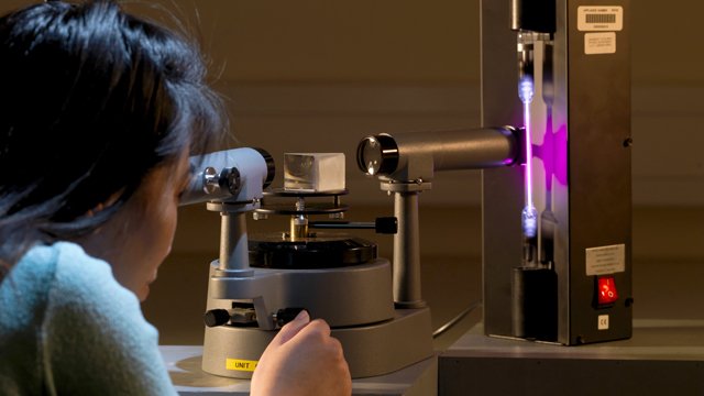 Female using physics equipment