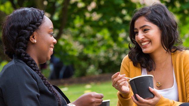 Two female students eating food