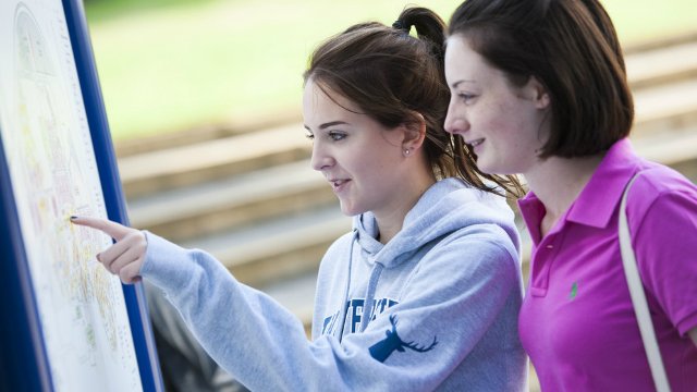 Two women looking at a map of campus