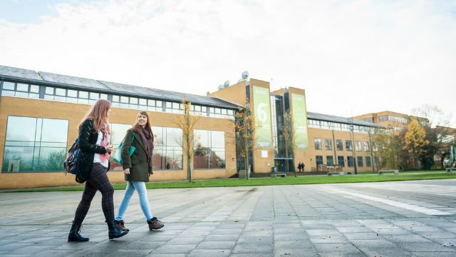 Two female students outside Austin Pearce building
