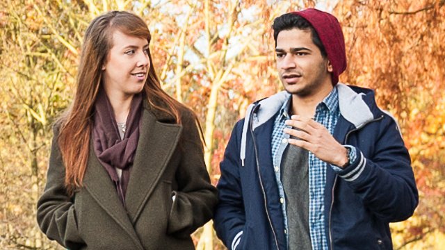 Two students talking by the lake