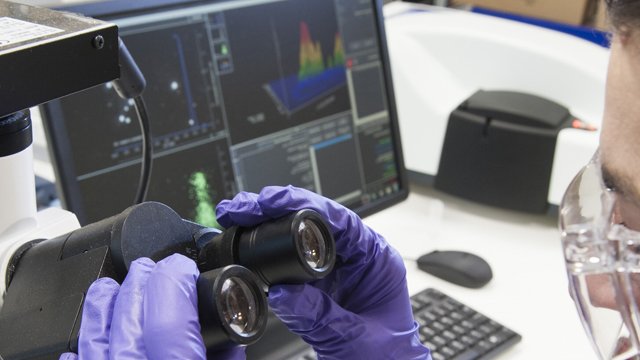 Man looking through microscope