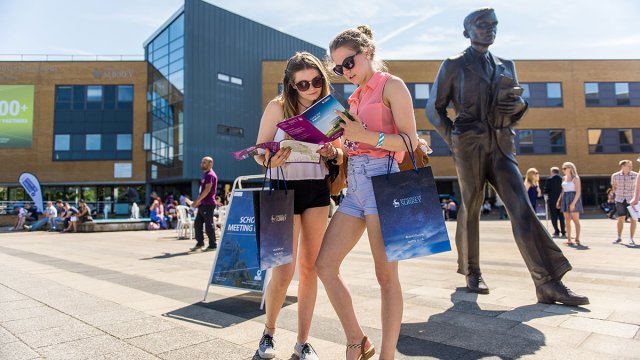 Students reading their welcome pack