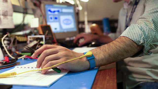 person with wire on their arm