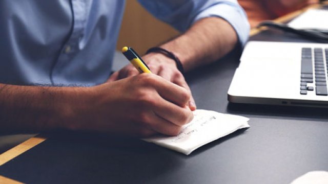 Man writing at a desk