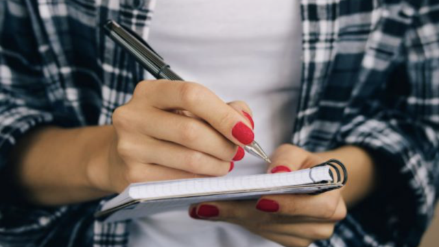 Student writing on notepad