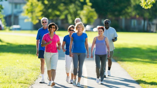 Group of people walking through park