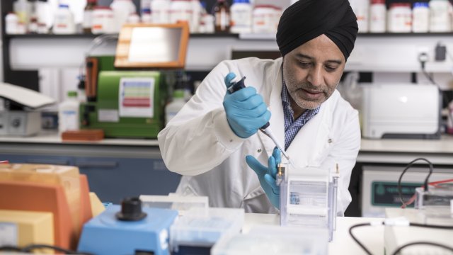 Hardev Pandha in the laboratory doing tests with tubes