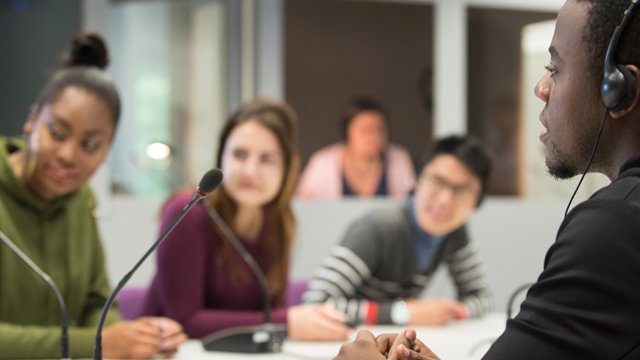 Group of students sat around a table