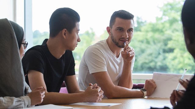 Group of students sat around a table