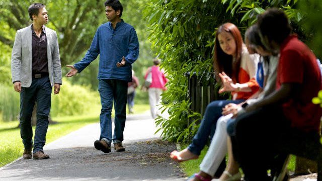 Students sitting by the lake having a discussion