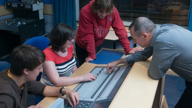 Students being shown how to use a soundboard
