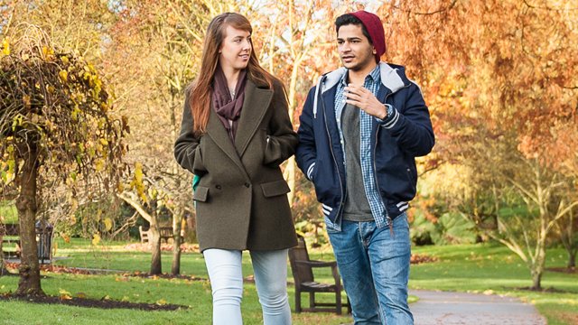 Two students talking by the lake