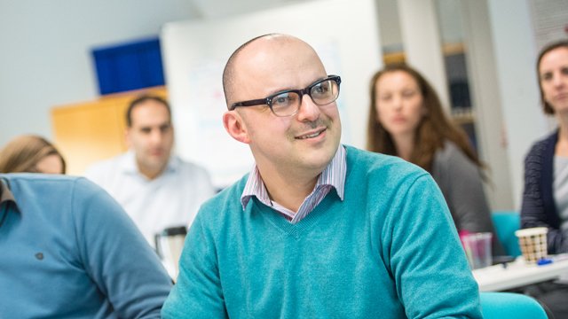 Male PhD student looking to the distance and smiling