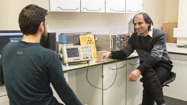 Academic and student sitting in a lab talking