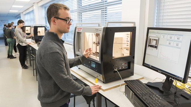 Student using physics equipment