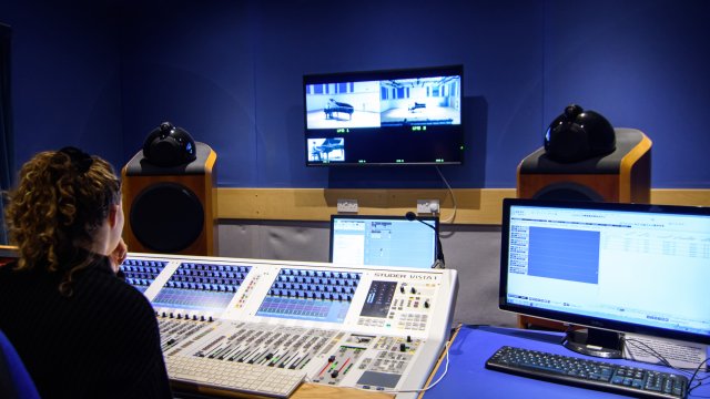 Female student using editing equipment