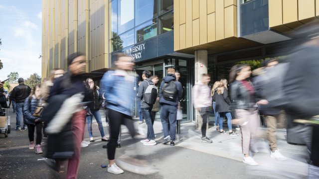 Staff walking past the library