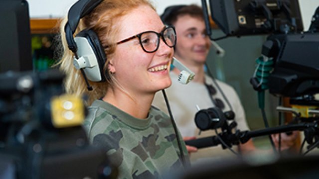 Film and video production students learning how to operate the broadcast studio for Surrey Television during a simulated programme.