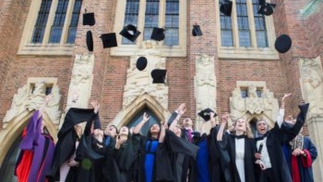 Graduates throwing hats into the air
