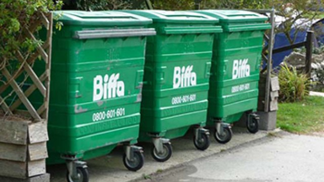 A row of three green bins