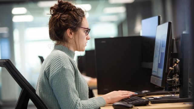 female student typing on computer 