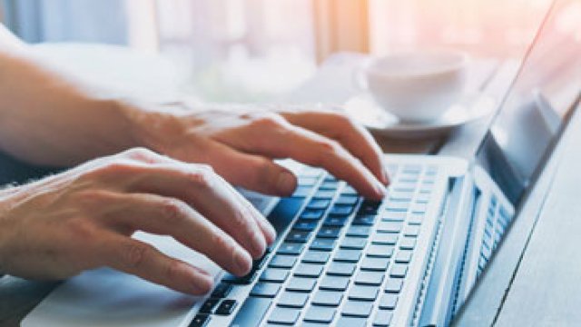 Person typing on a keyboard