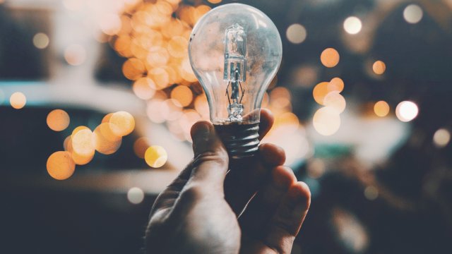 Hand holding a lightbulb image 