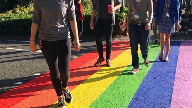 People walking across the University's permanent rainbow crossing
