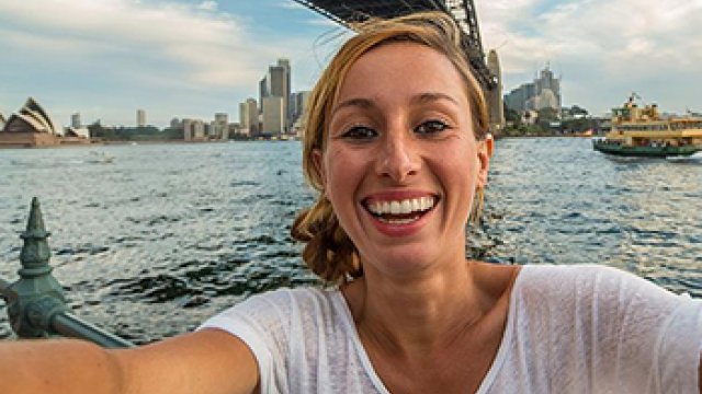 A young women talking a selfie at the Sydney Harbour bridge.