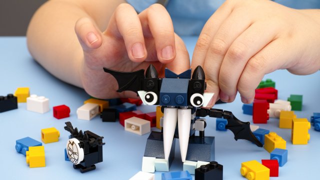 A child is playing with Lego bricks.