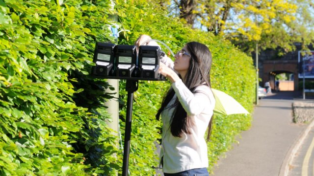 Woman measuring air quality at Stoke Road
