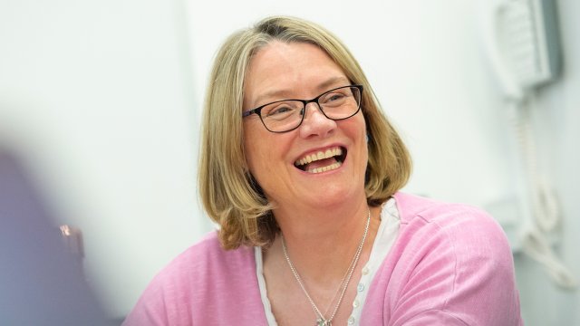 Female with glasses laughing