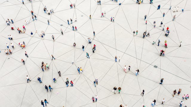 An aerial shot of a crowd of people with lines connecting them