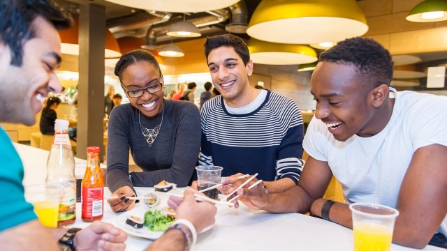 Four students eating sushi