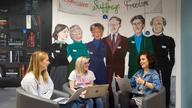 Three female student sat talking