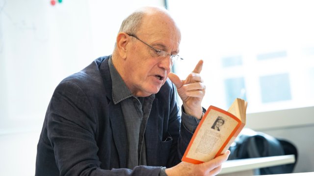 Iain Sinclair reading a book