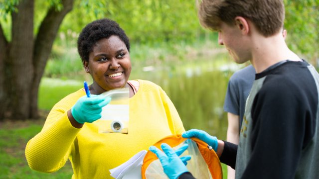 Student holding sample in a bag, collected from a lake