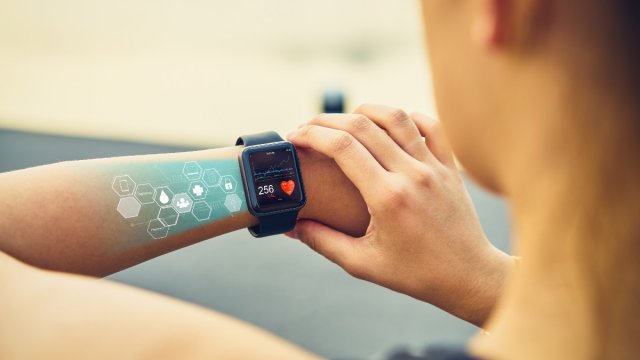 Woman using a watch with heart monitor app