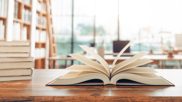 Open book on table in a library