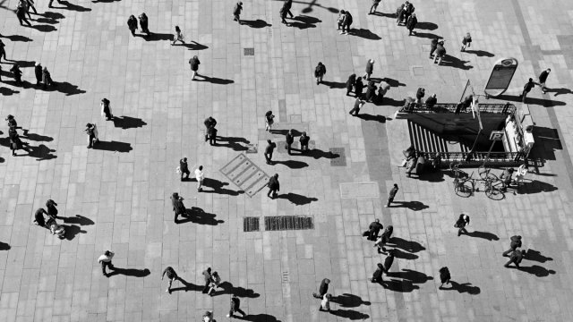 Lots of people walking in a plaza