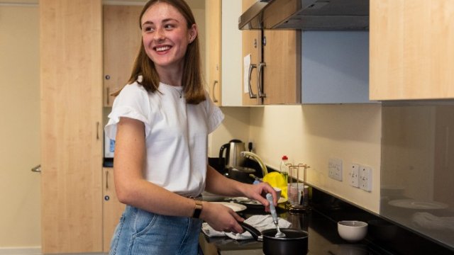 Student in kitchen of university accommodation