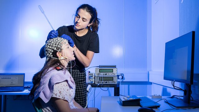 Student setting up EEG equipment