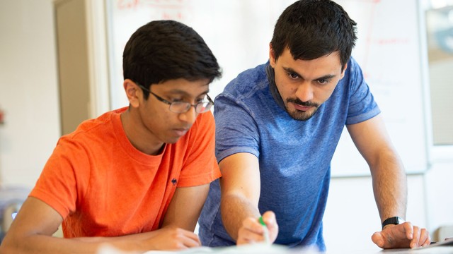 Mechanical engineering student with teacher