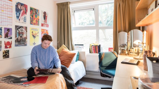 A student relaxing in our on-campus accommodation