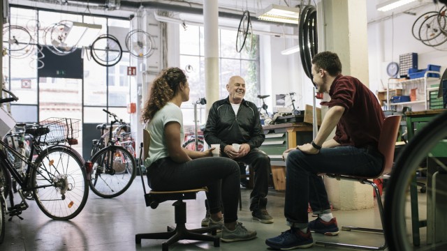 People sitting and talking in a bike shop